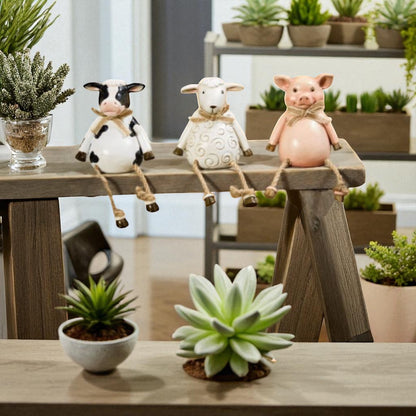 Pig, cow and sheep farm animal shelf sitter ornaments in neutral country style, sitting on a wooden windowsill with dangling legs