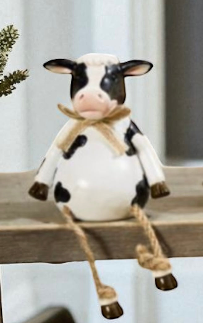 Pig, cow and sheep farm animal shelf sitter ornaments in neutral country style, sitting on a wooden windowsill with dangling legs